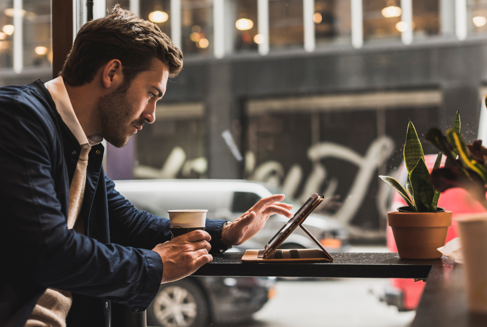 Usa, New York City, Businessman Sitting In Coffee Shop, Using Digital Tablet