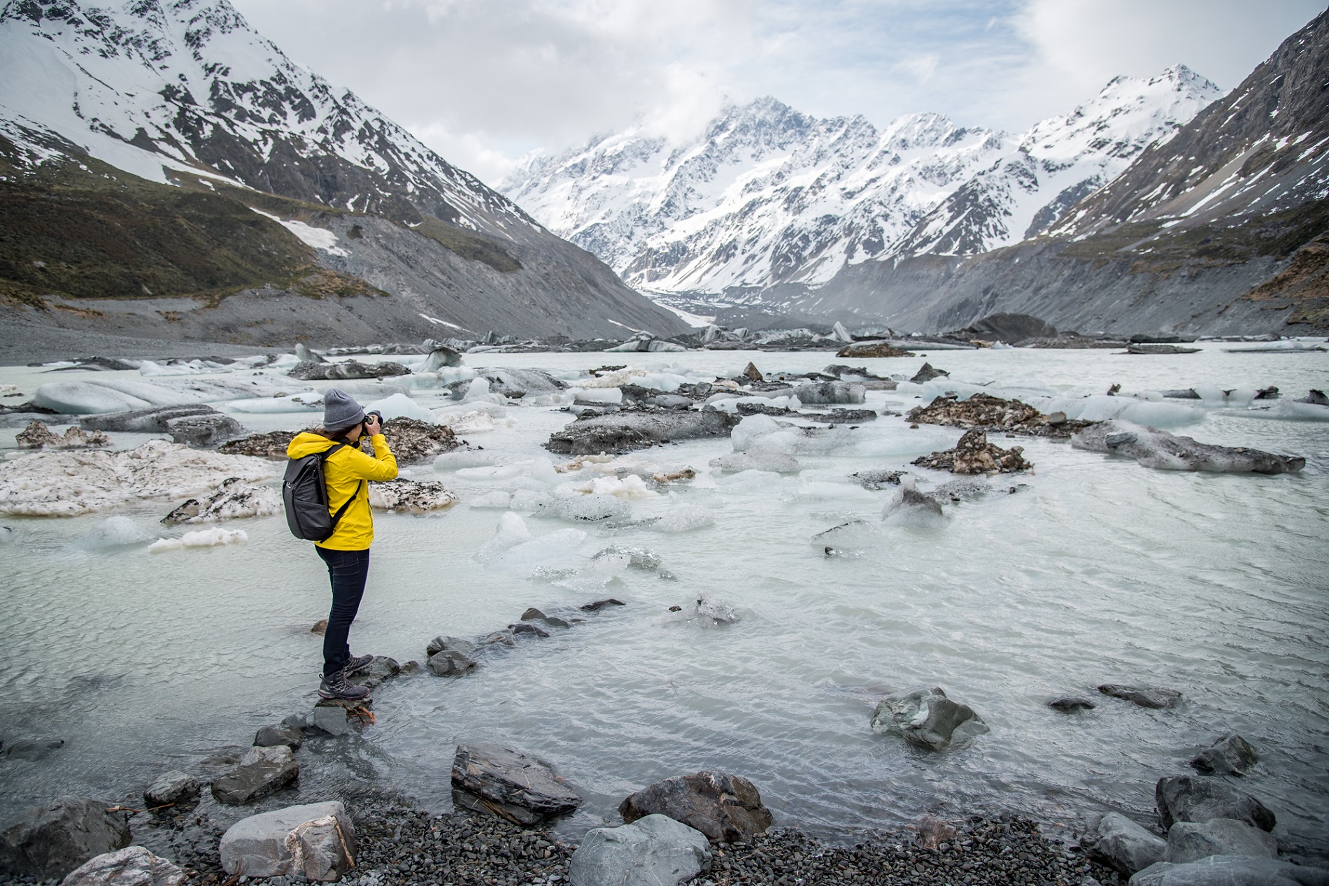 Young Asian Woman Taking Photos On Hooker Glacier In Aoraki / Mount Cook National Park, New Zealand